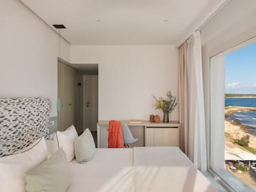 a bedroom with a bed and a desk