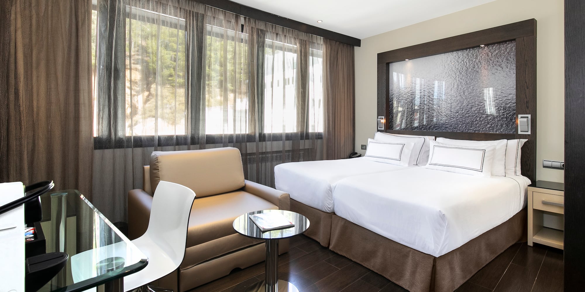 a room with two beds and a chair