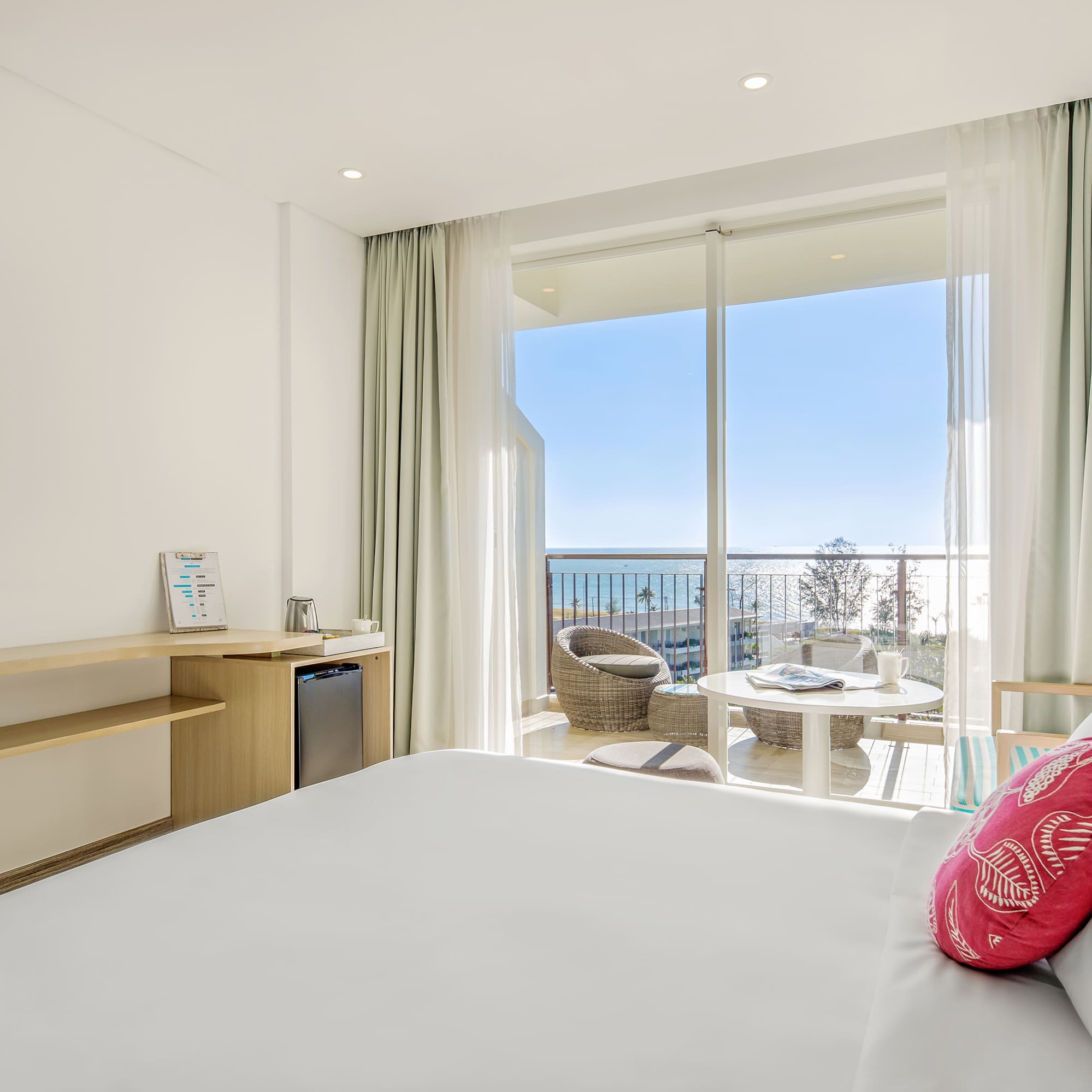 a room with a bed and a table and chairs