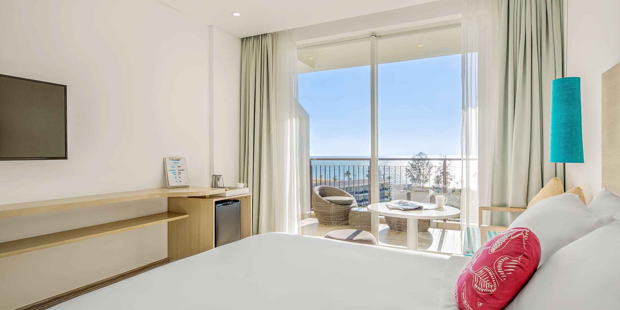 a room with a bed and a table and chairs