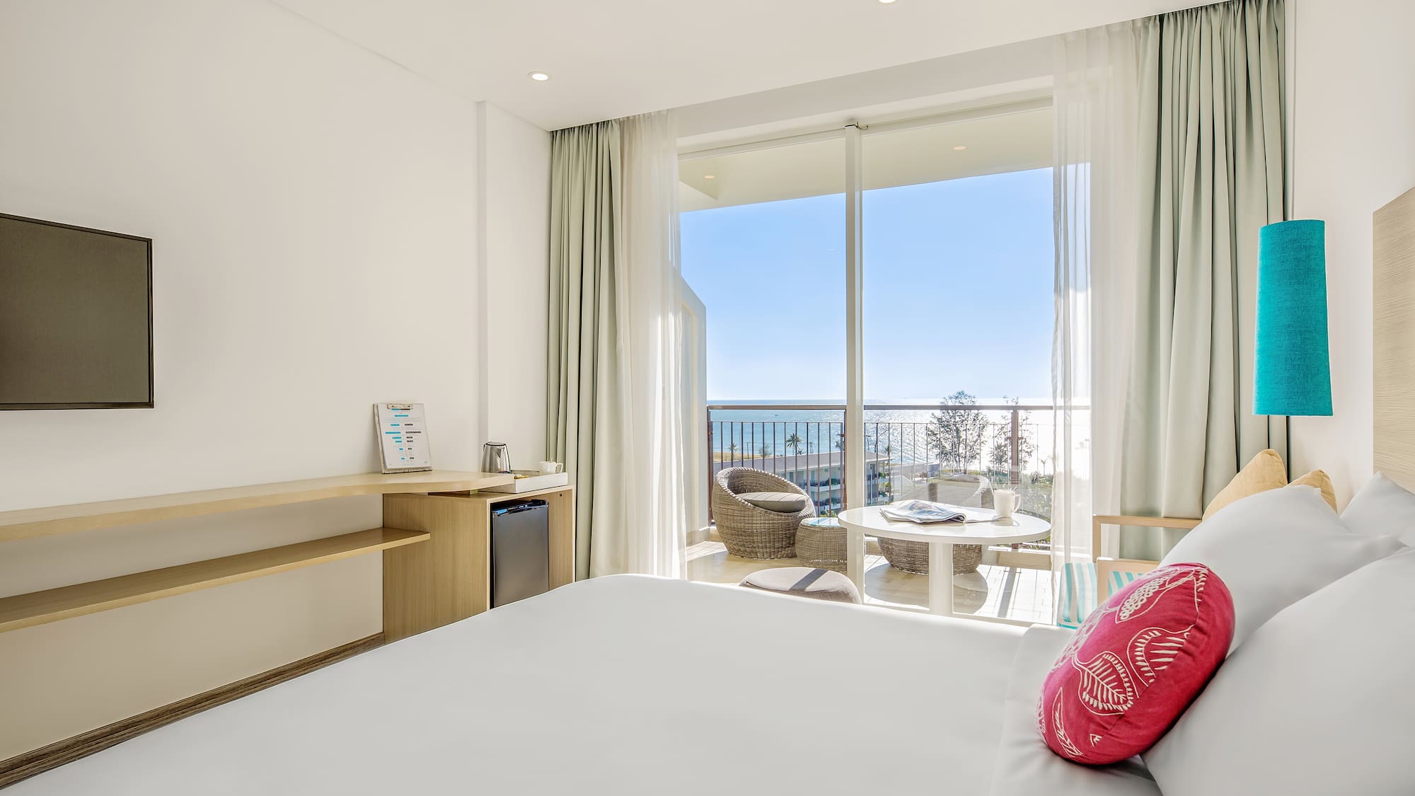 a room with a bed and a table and chairs