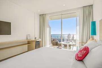 a room with a bed and a table and chairs