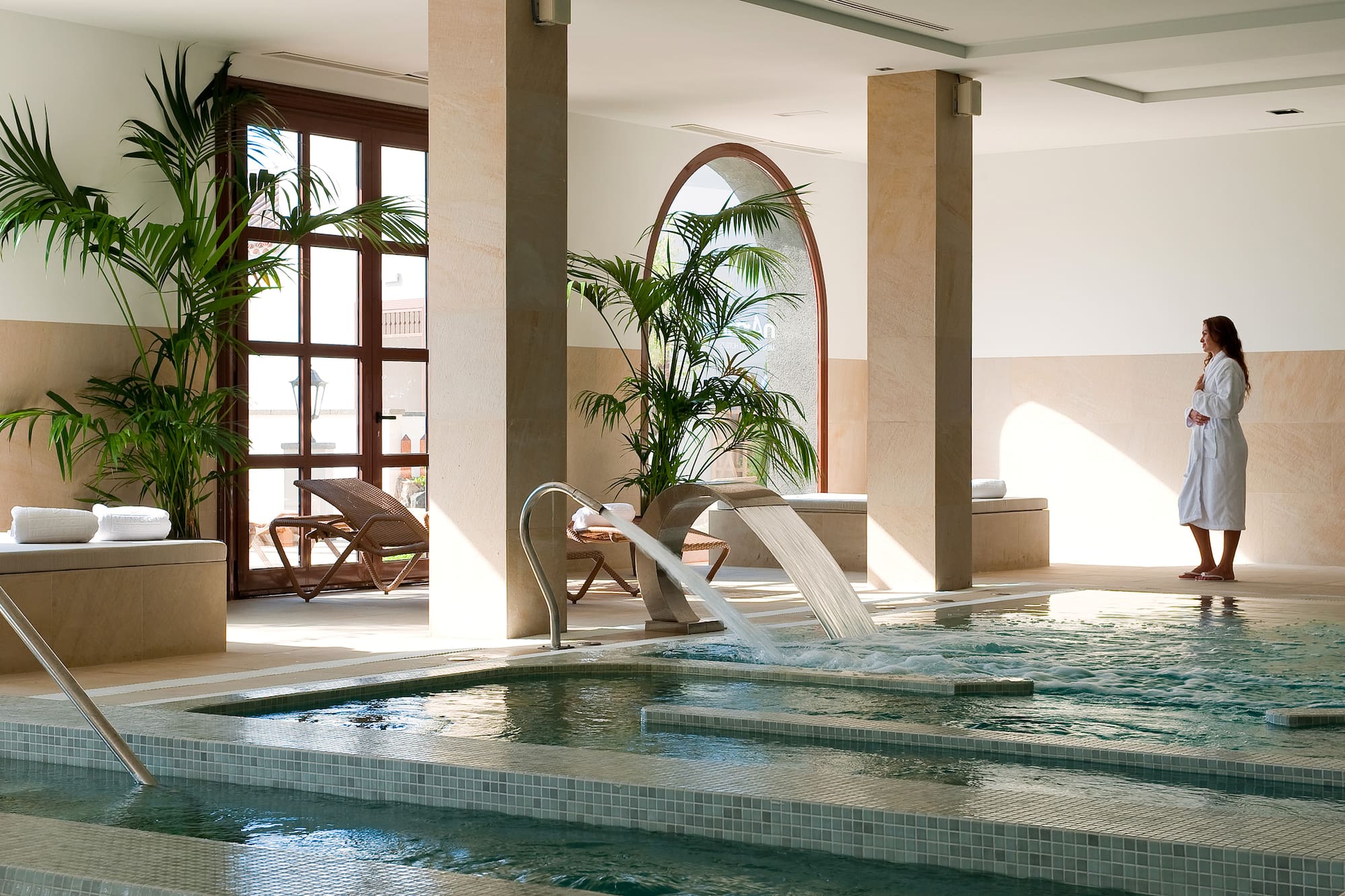 a indoor pool with a waterfall
