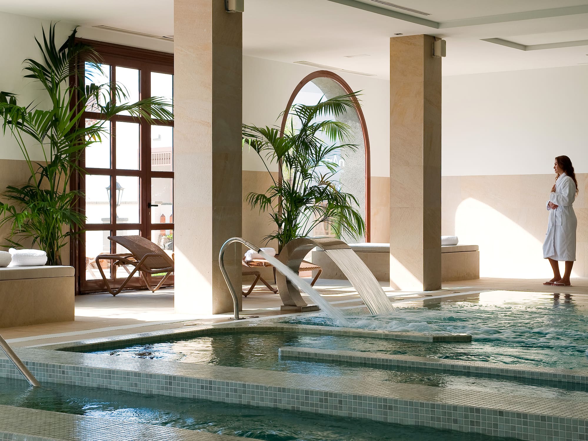 a indoor pool with a waterfall