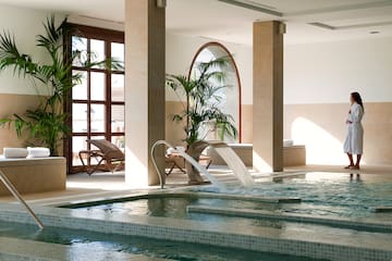 a indoor pool with a waterfall