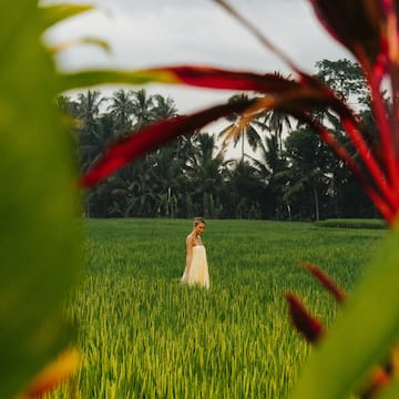 a woman standing in a field of grass