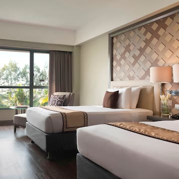 a room with two beds and a window
