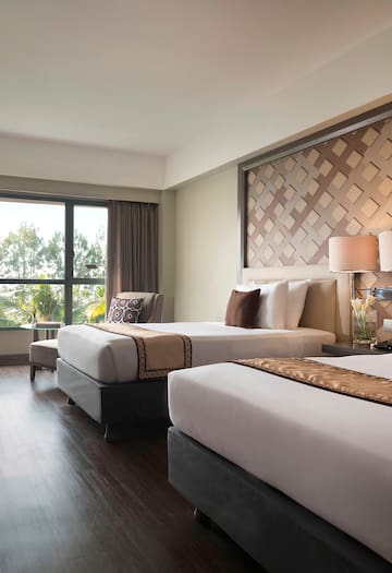 a room with two beds and a window