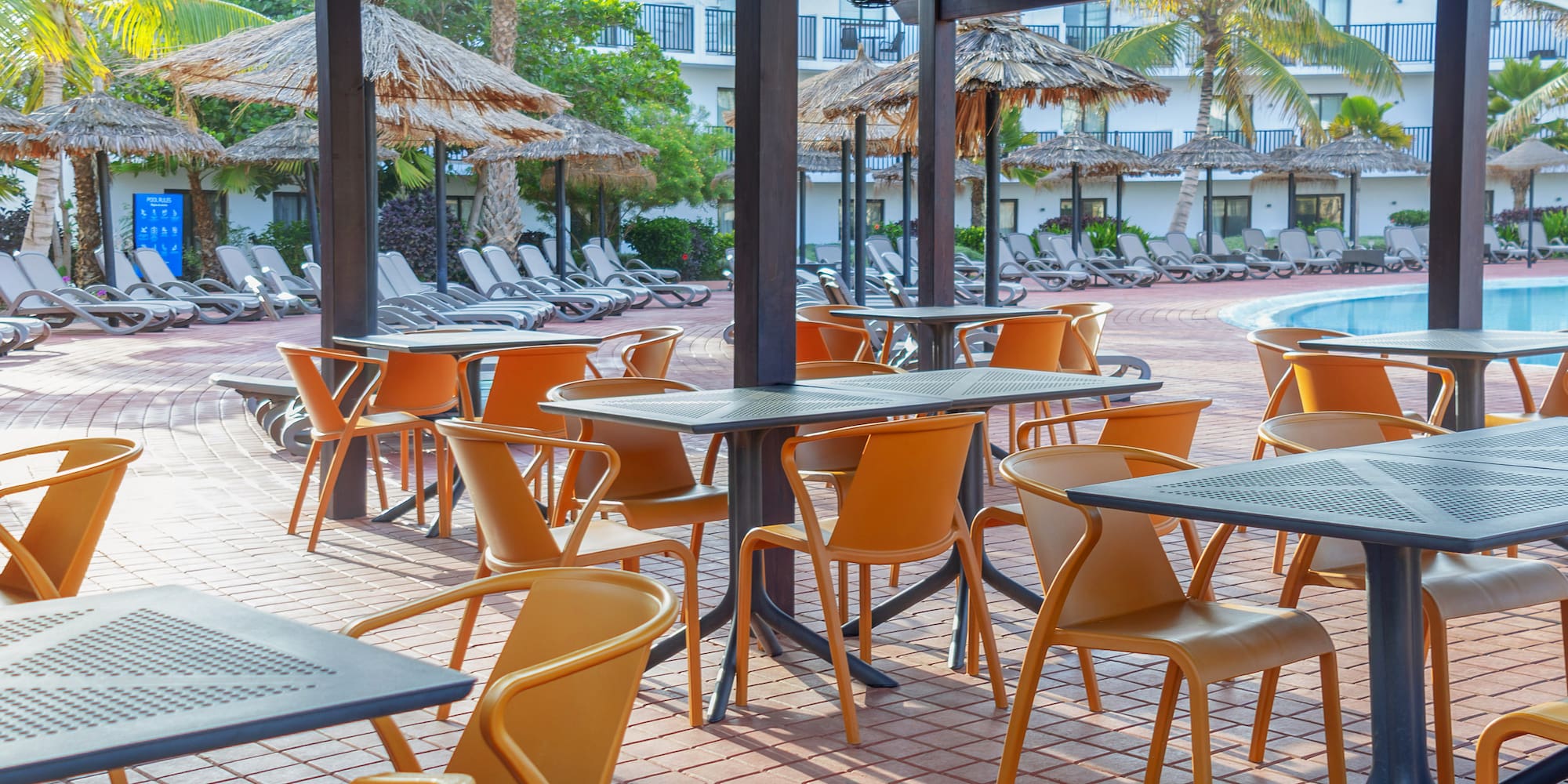 a patio with tables and chairs