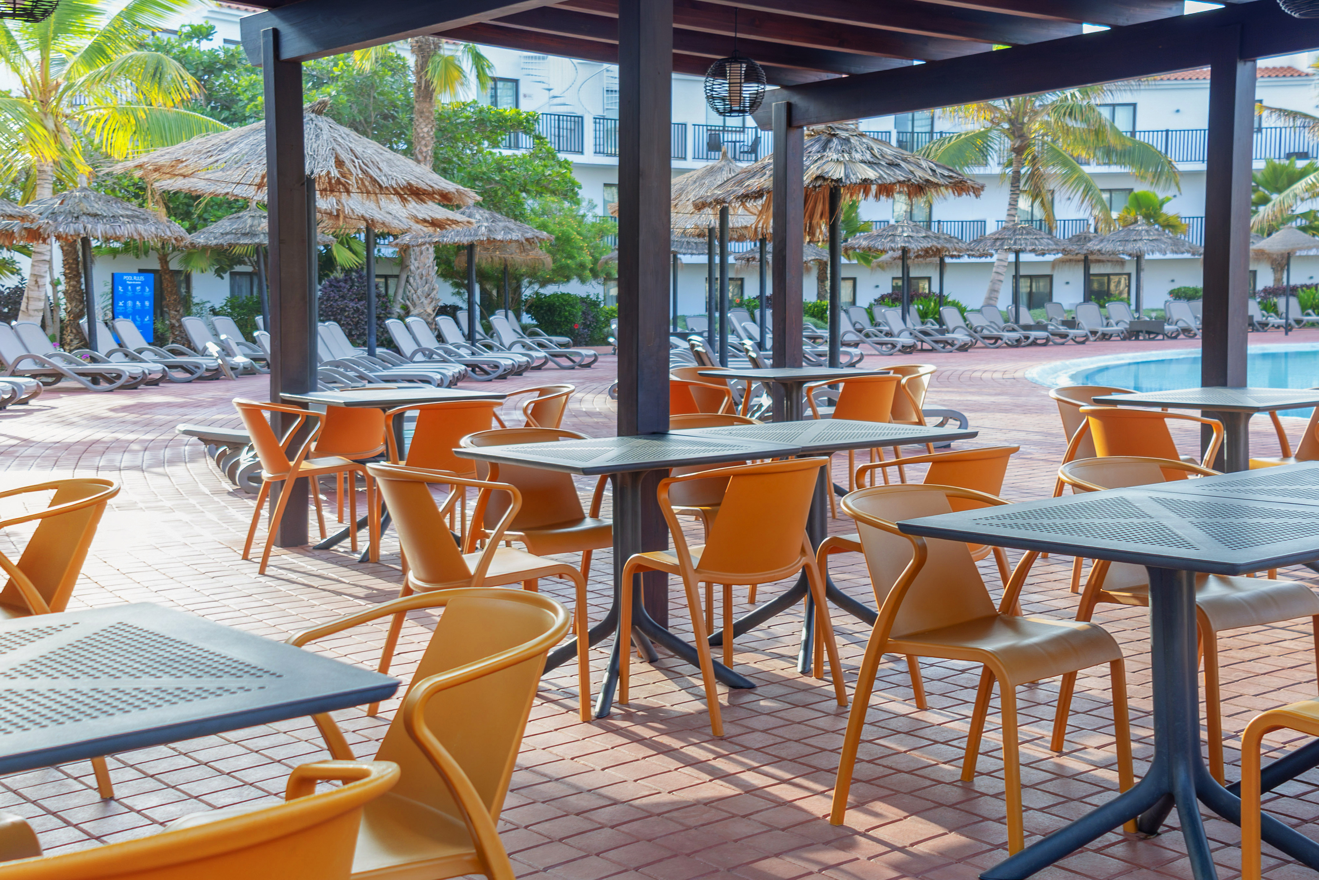 a patio with tables and chairs