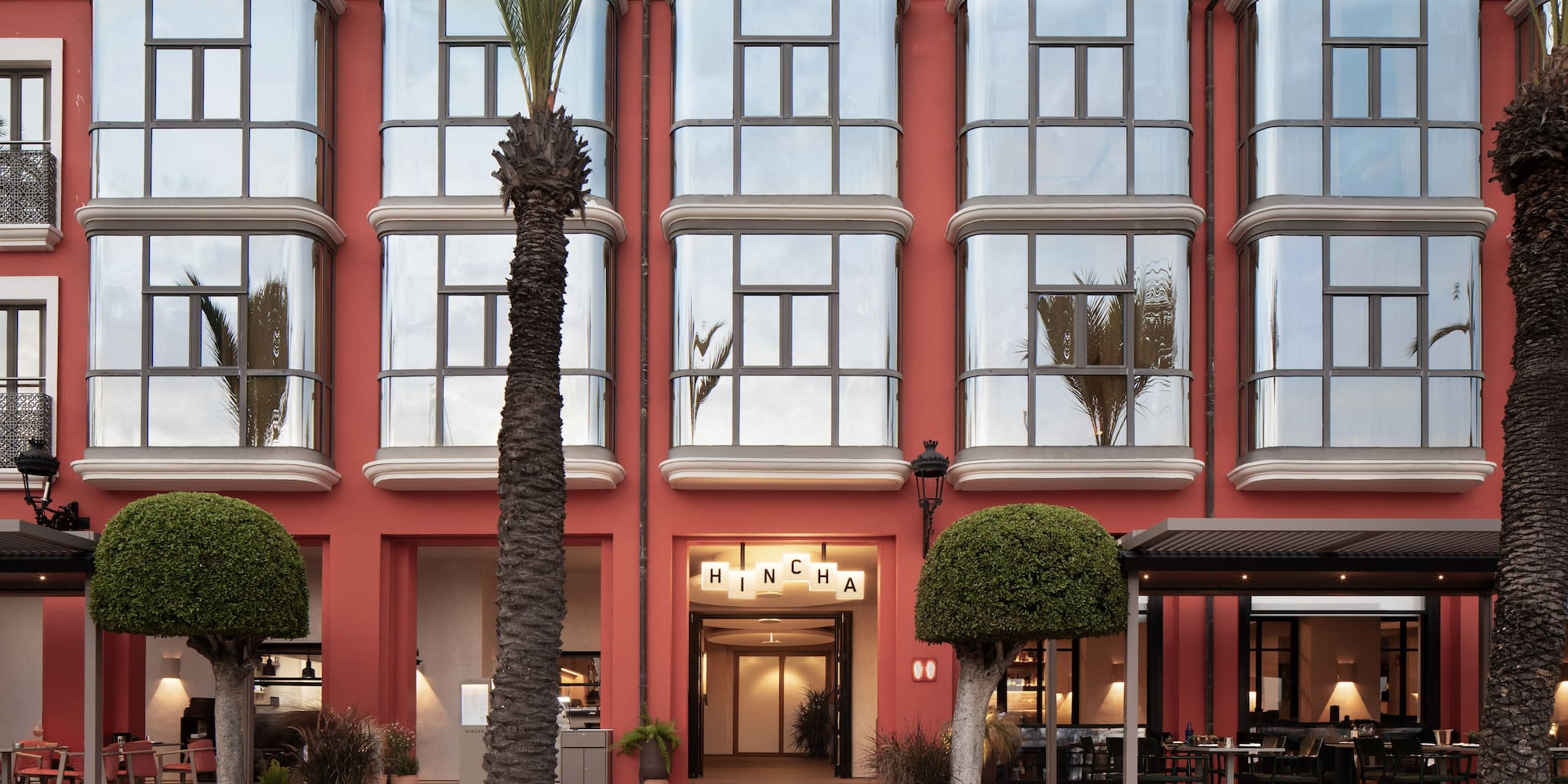 a building with a red wall and windows