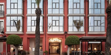a building with a red wall and windows