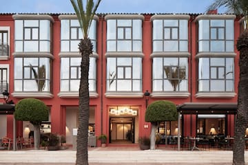 a building with a red wall and windows