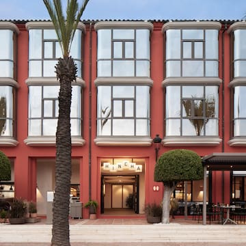 a building with a red wall and windows