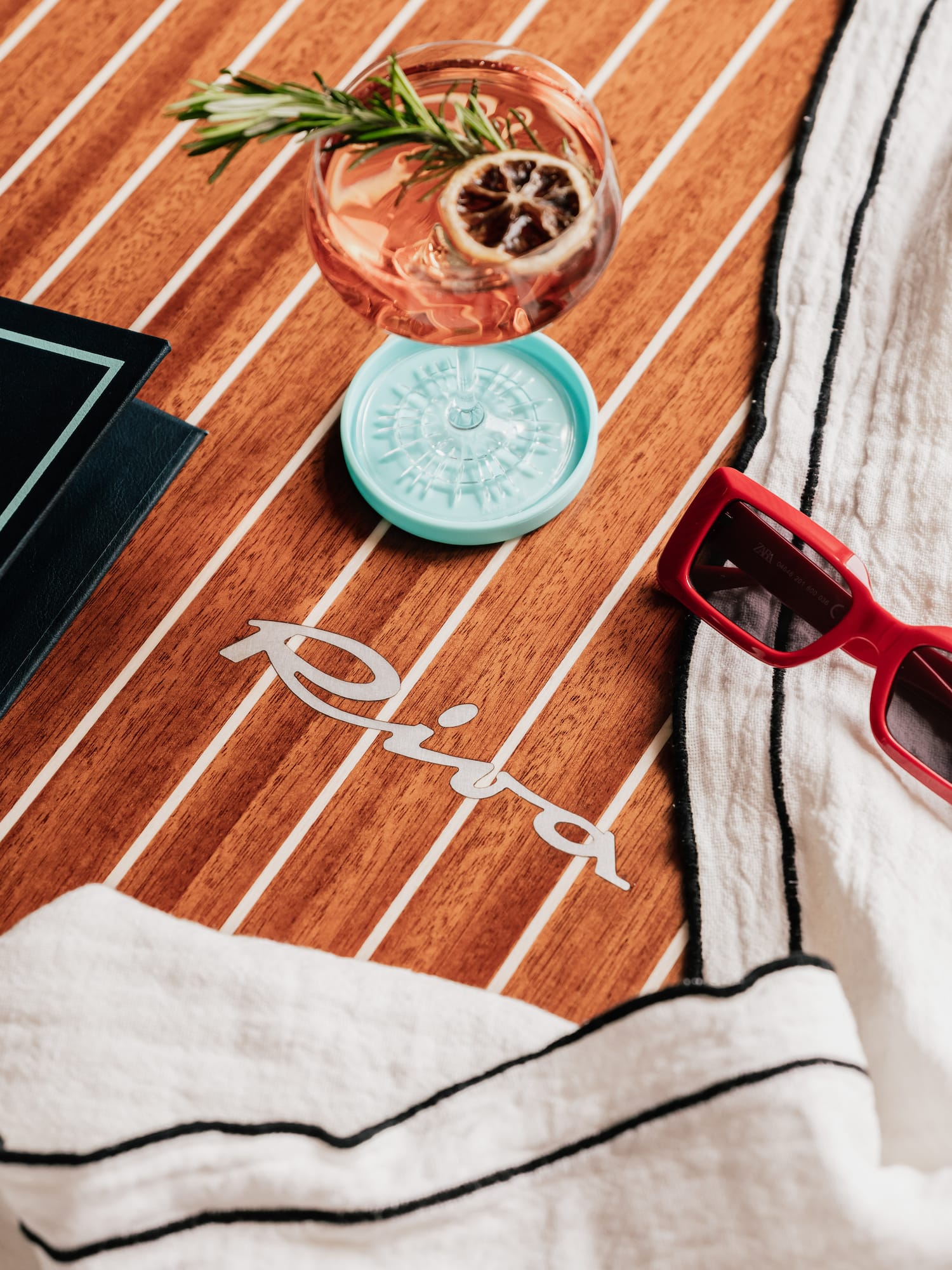 a drink and sunglasses on a table