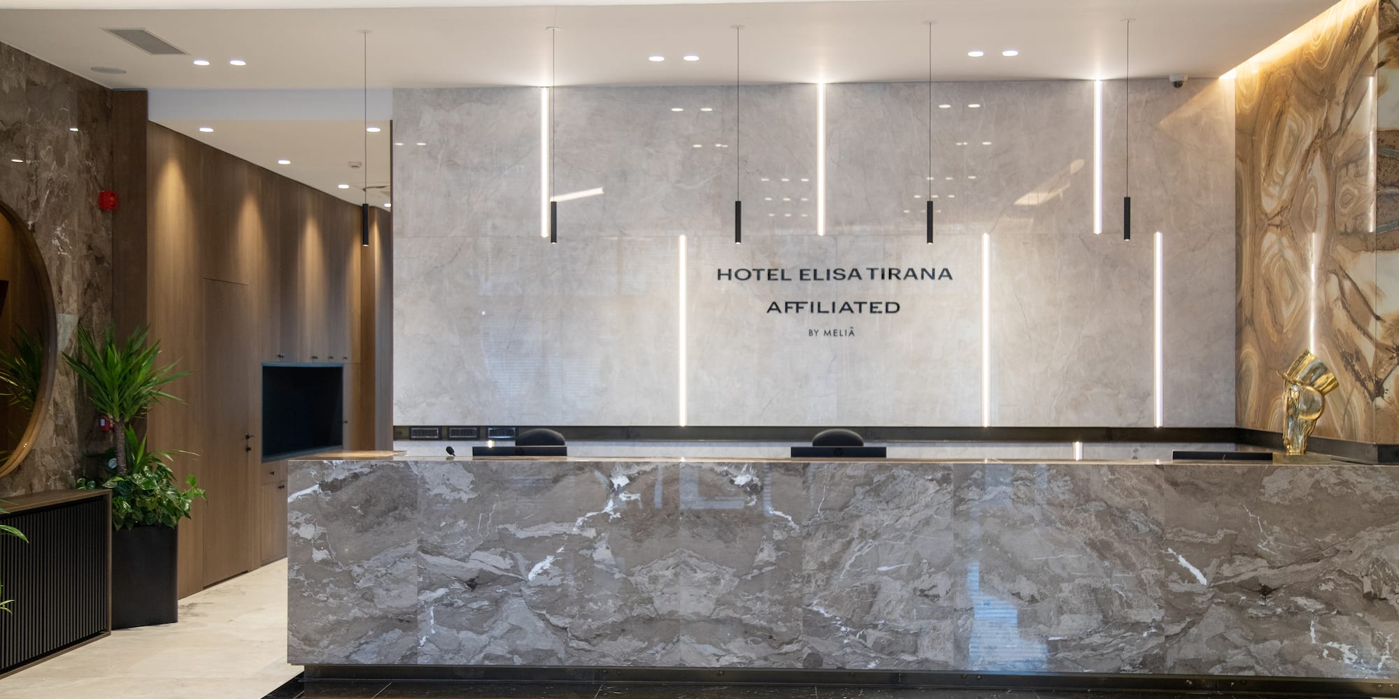 a marble reception desk in a hotel