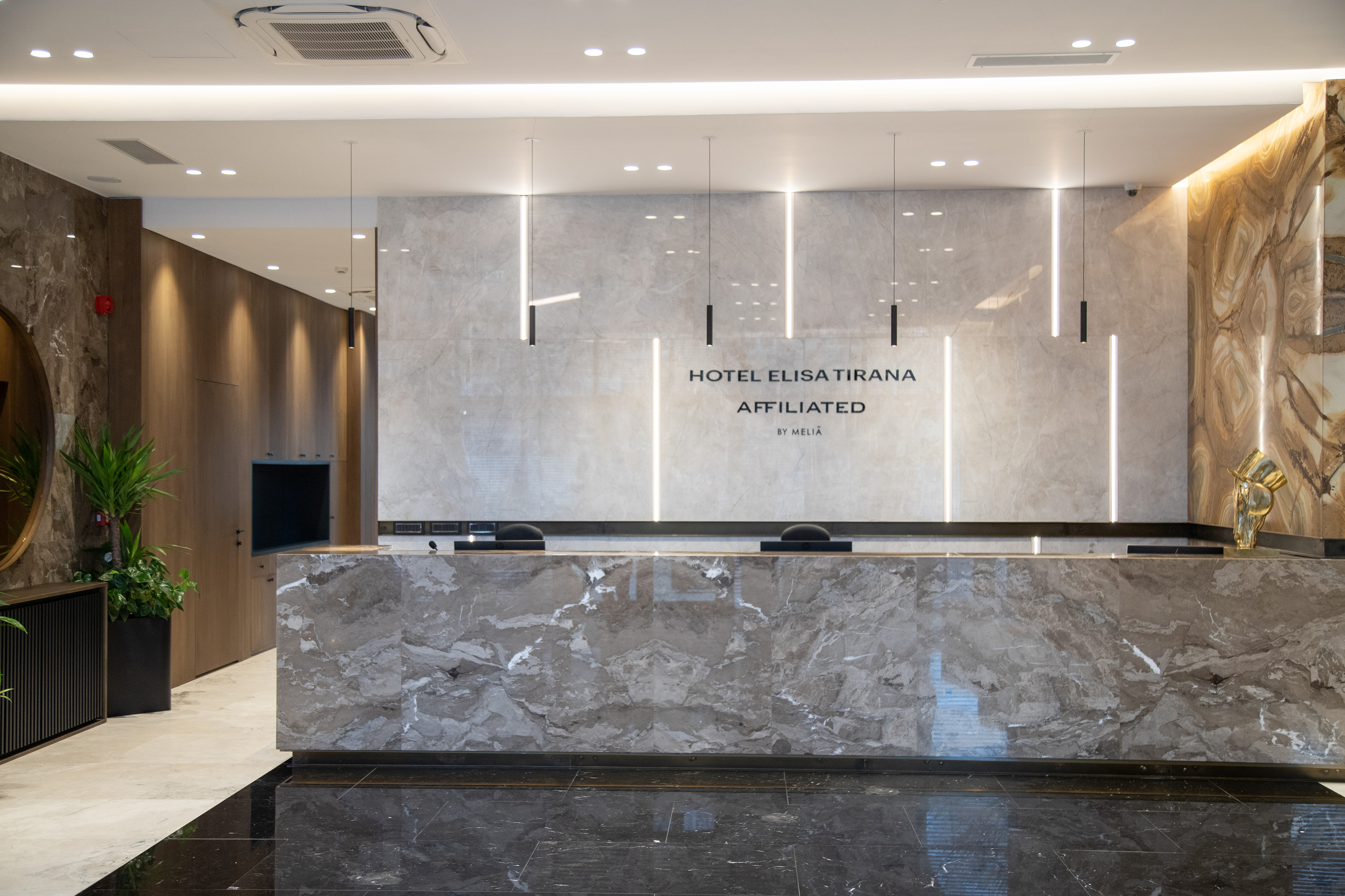 a marble reception desk in a hotel