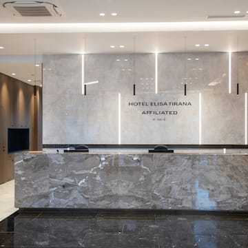 a marble reception desk in a hotel