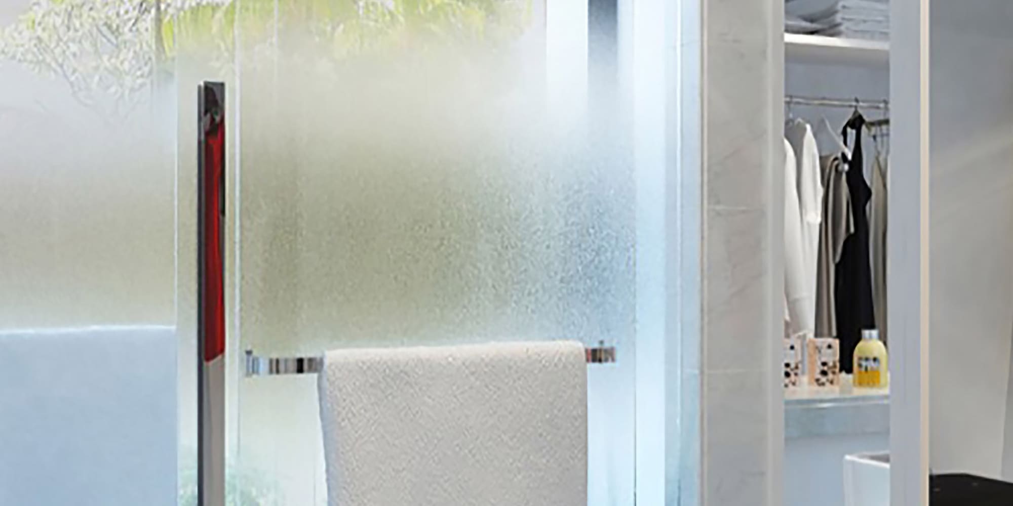 a shower door with a towel on it