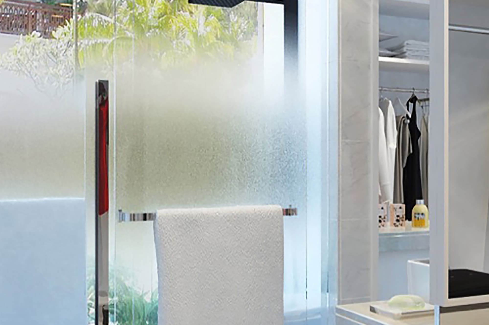 a shower door with a towel on it