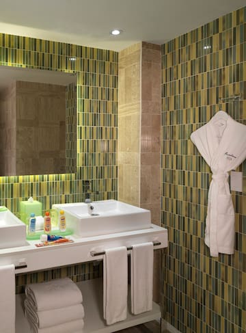 a bathroom with a white robe and sink