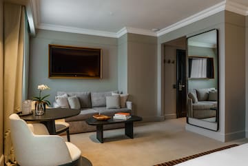 a living room with a mirror and couches