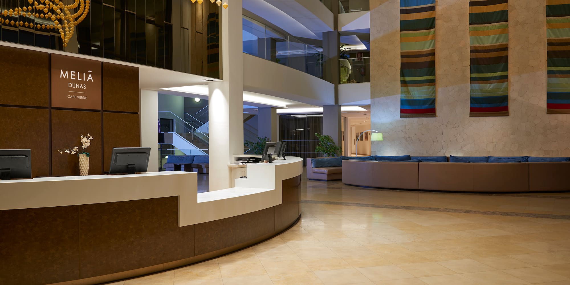 a lobby with a reception desk and a couch