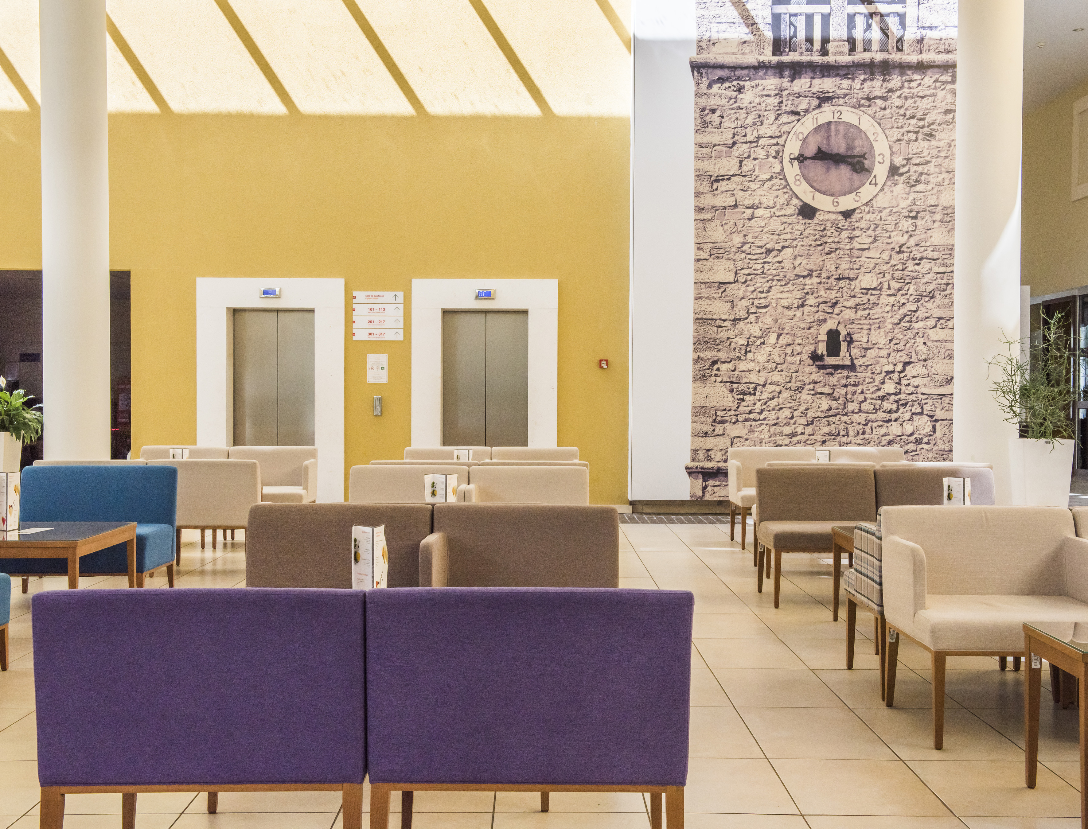 a room with chairs and a clock