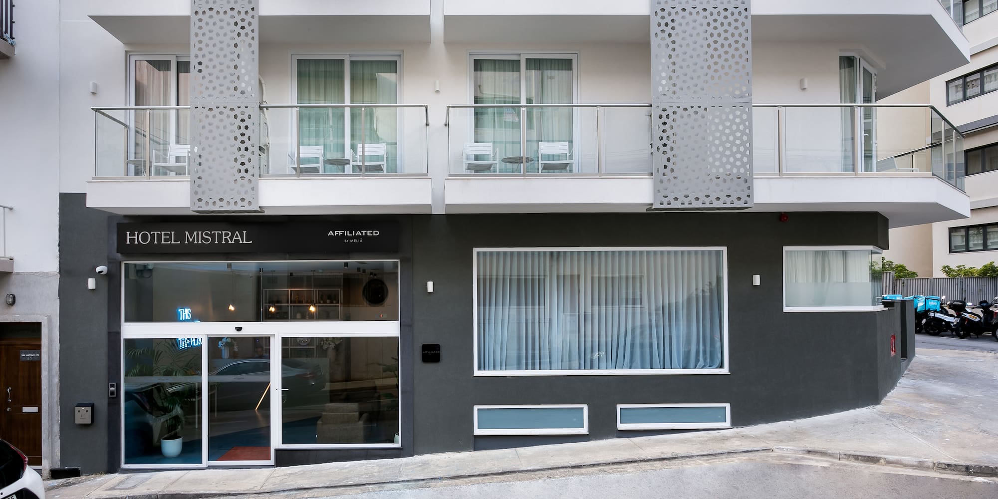 a building with a street and a parking lot