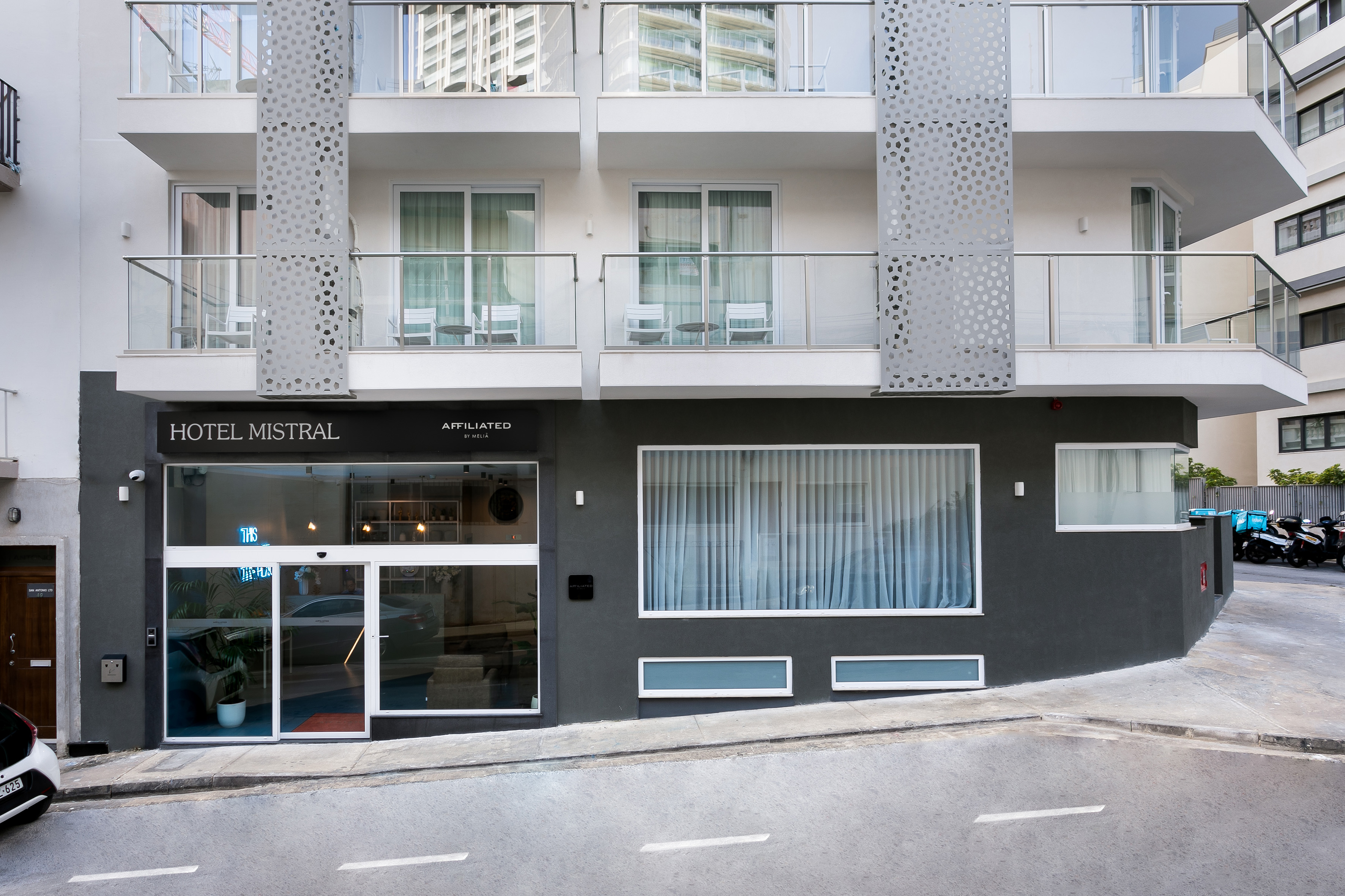 Modern Hotel Mistral exterior with balconies and street view.