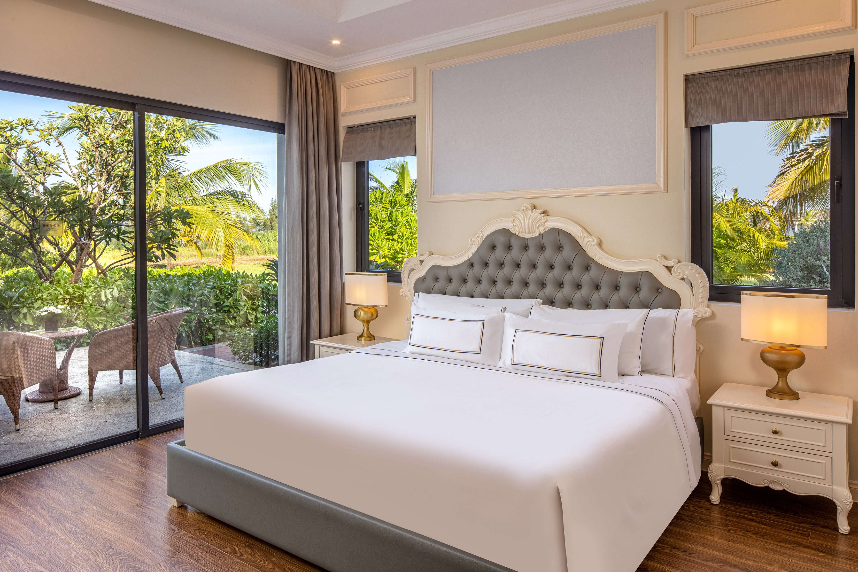 a bed in a room with glass doors