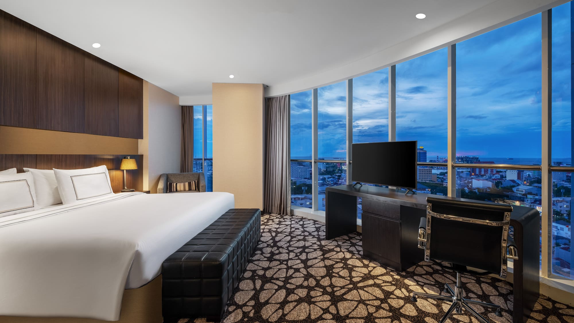 a room with a large window and a bed