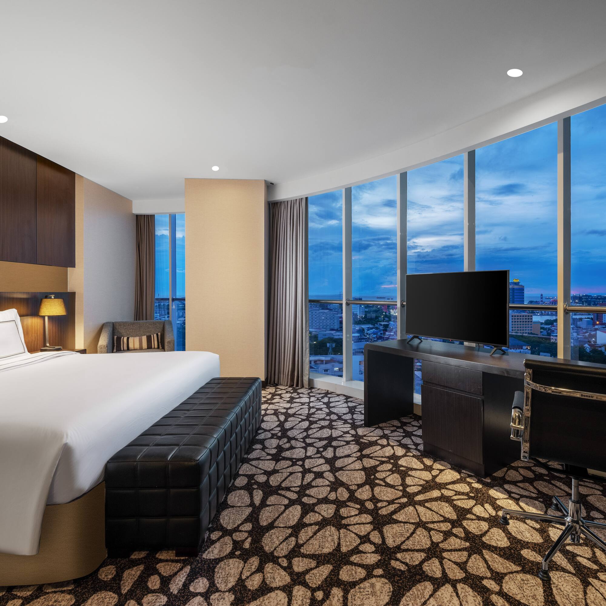 a room with a large window and a bed