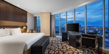 a room with a large window and a bed