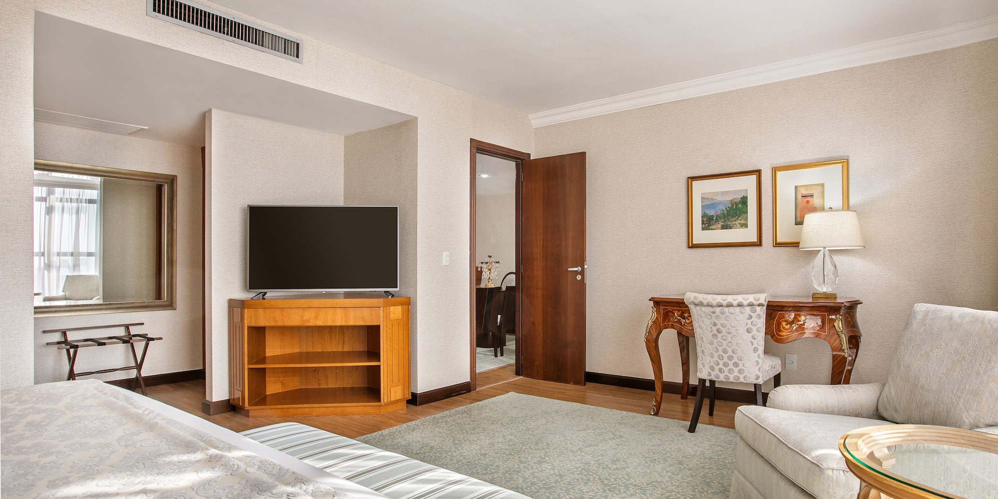 a room with a bed and a television