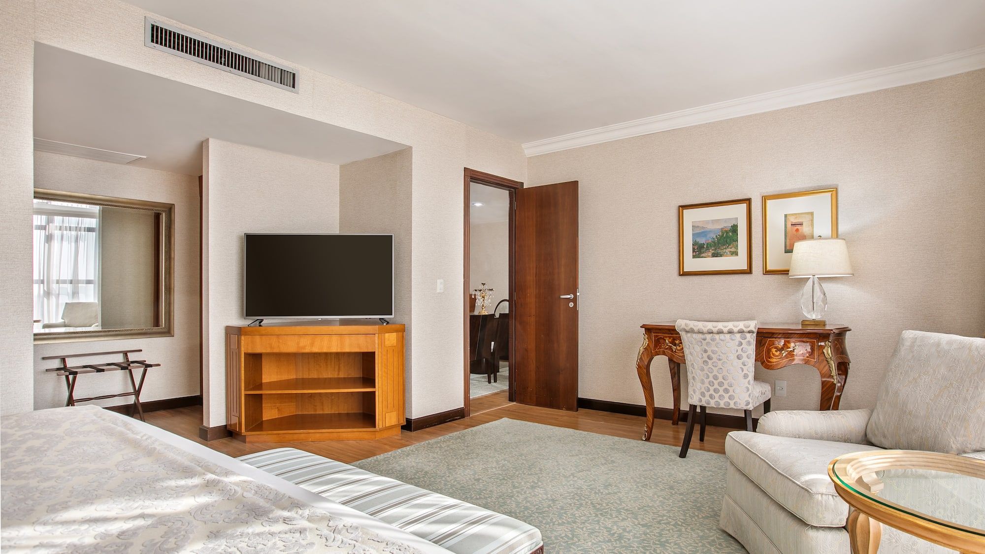 a room with a bed and a television