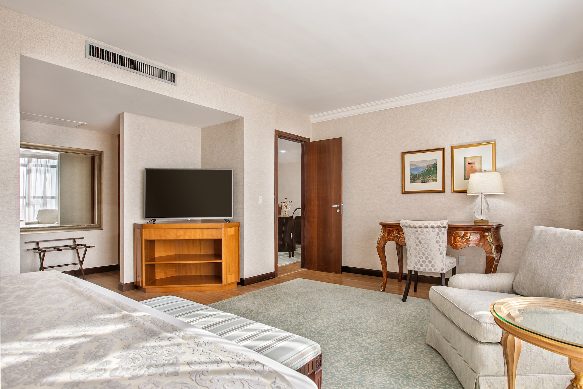 a room with a bed and a television