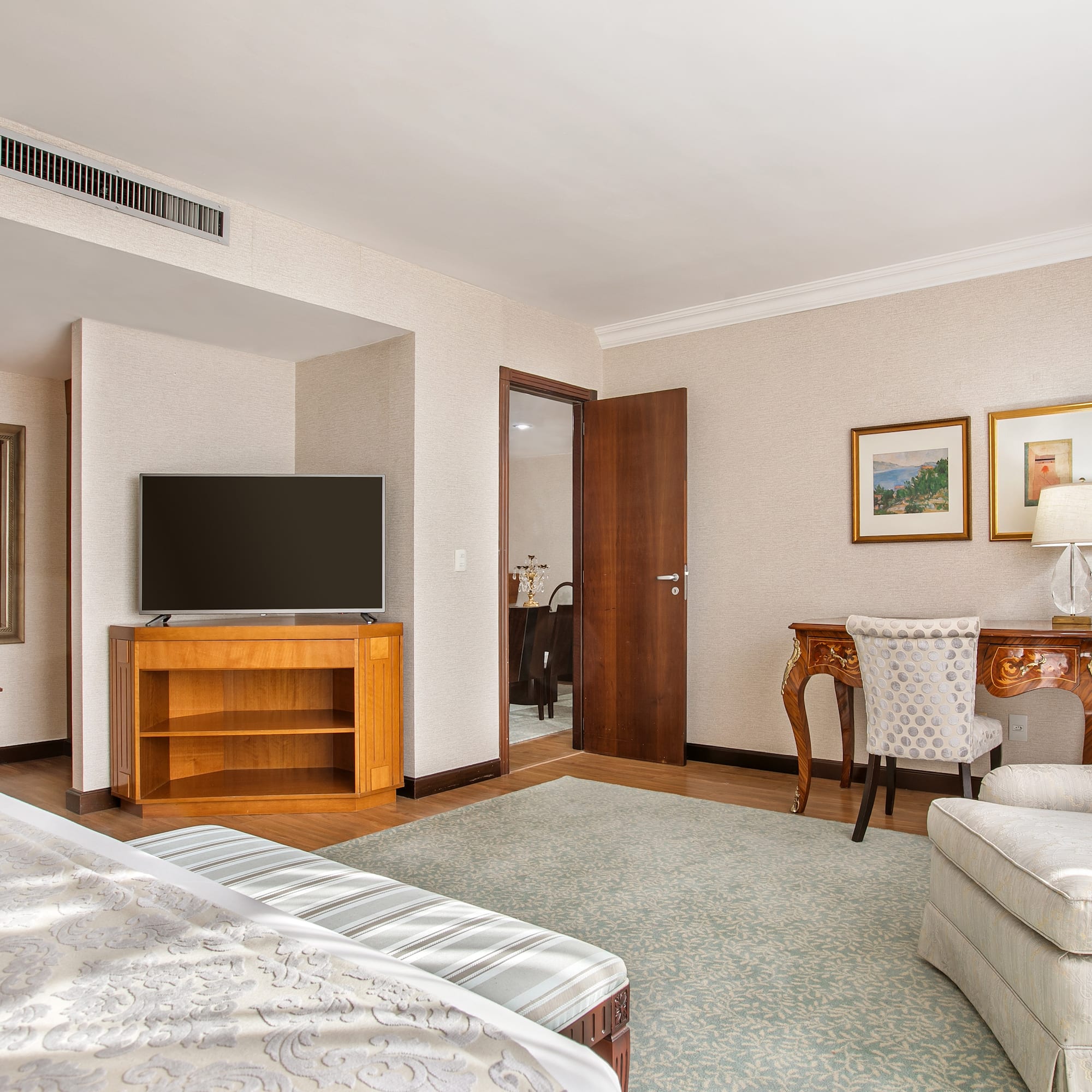 a room with a bed and a television