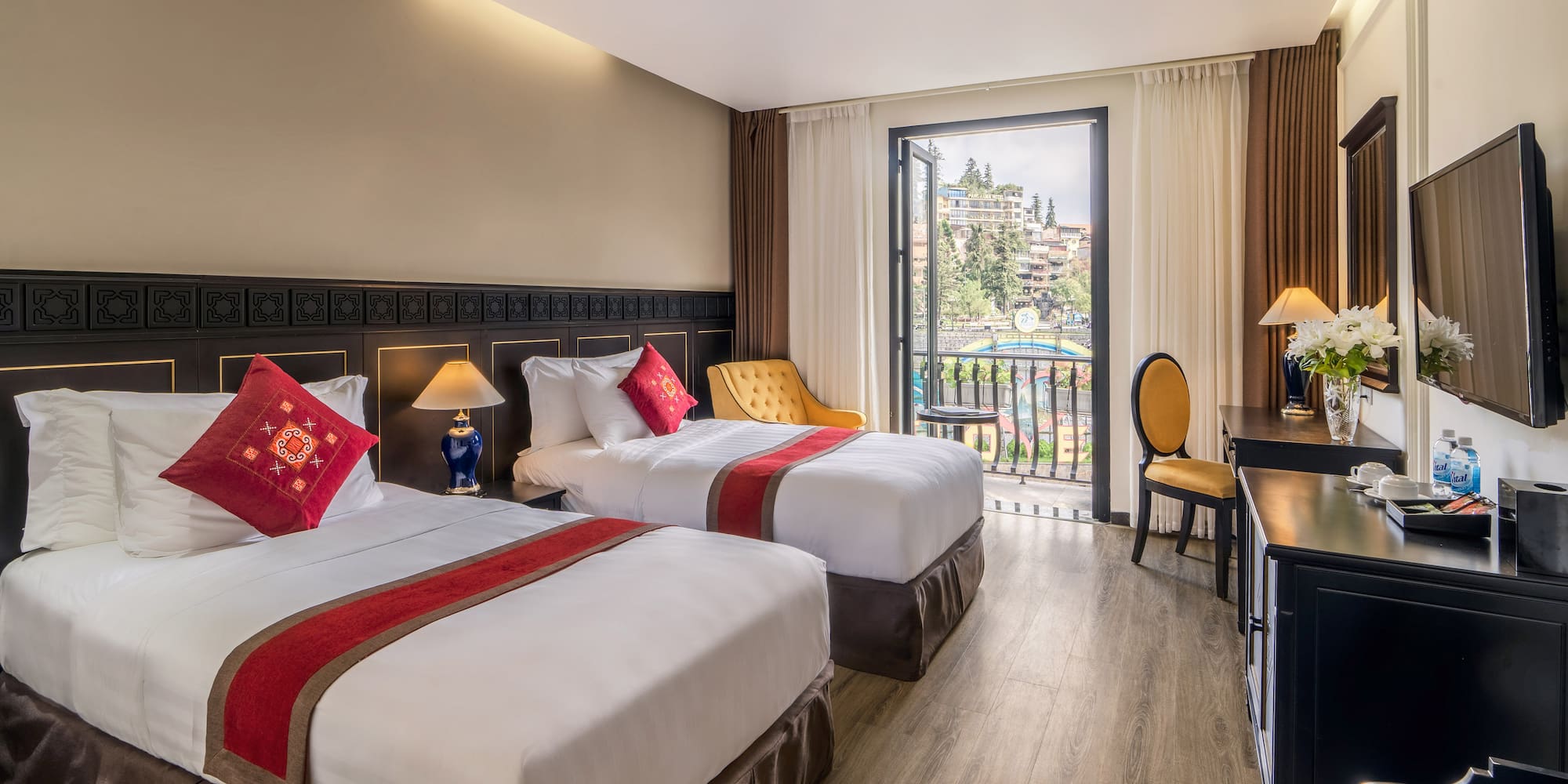 a room with two beds and a desk