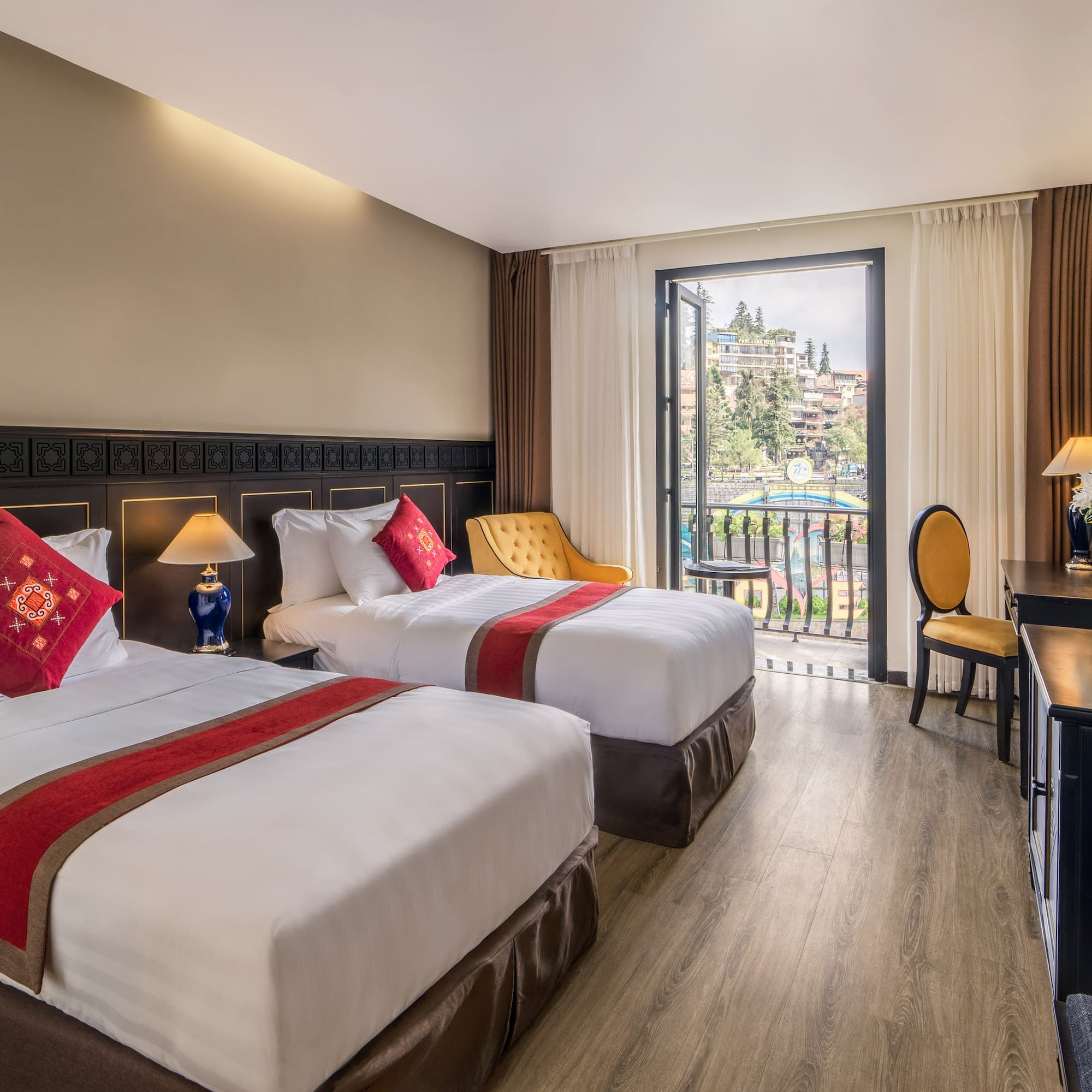 a room with two beds and a desk