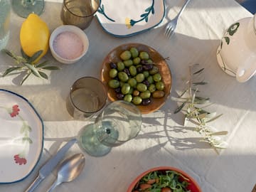 a table with plates and bowls of food