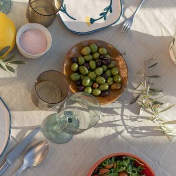 a table with plates and bowls of food