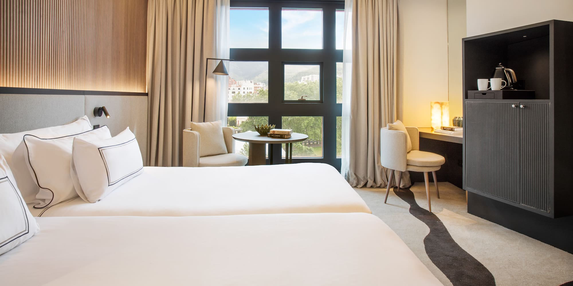 a room with two beds and a fireplace