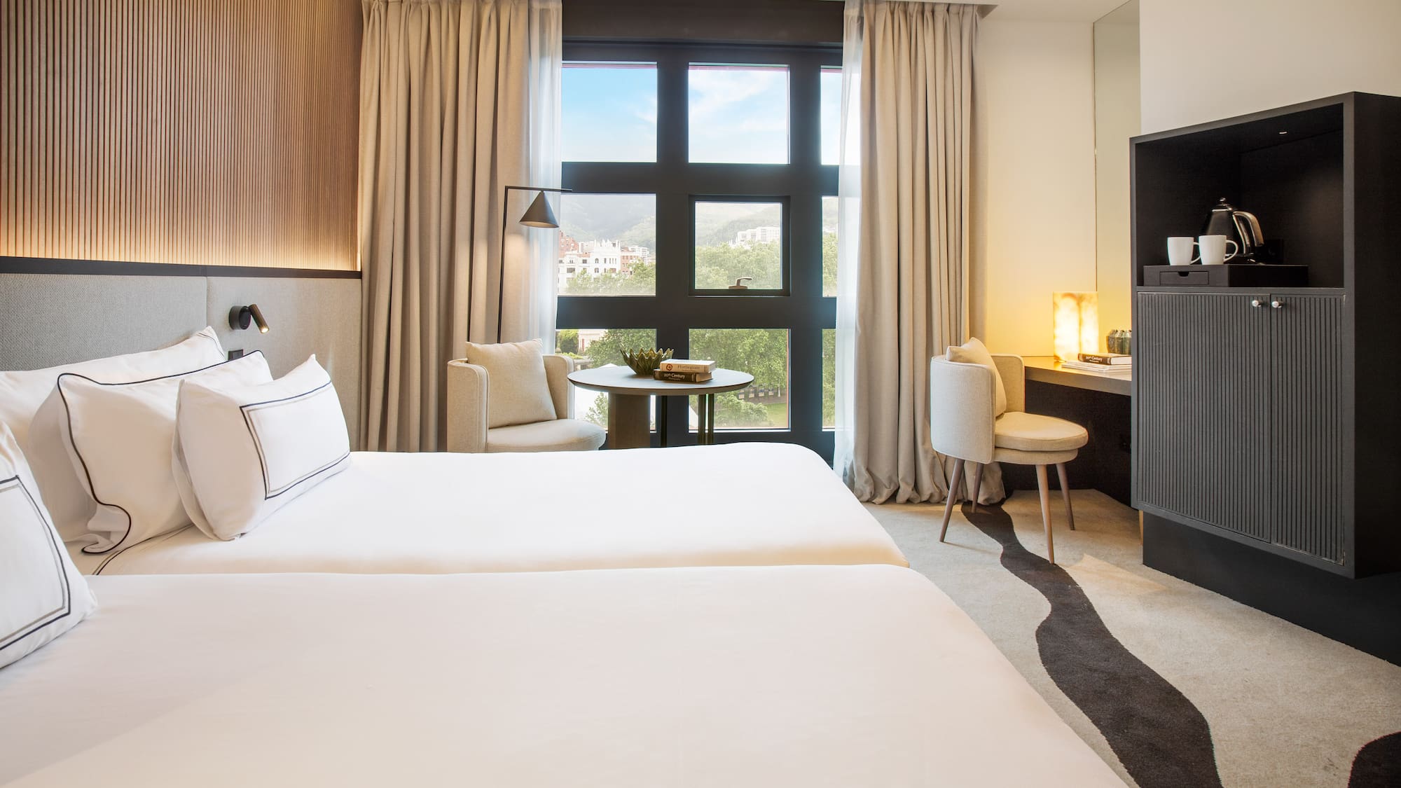 a room with two beds and a fireplace