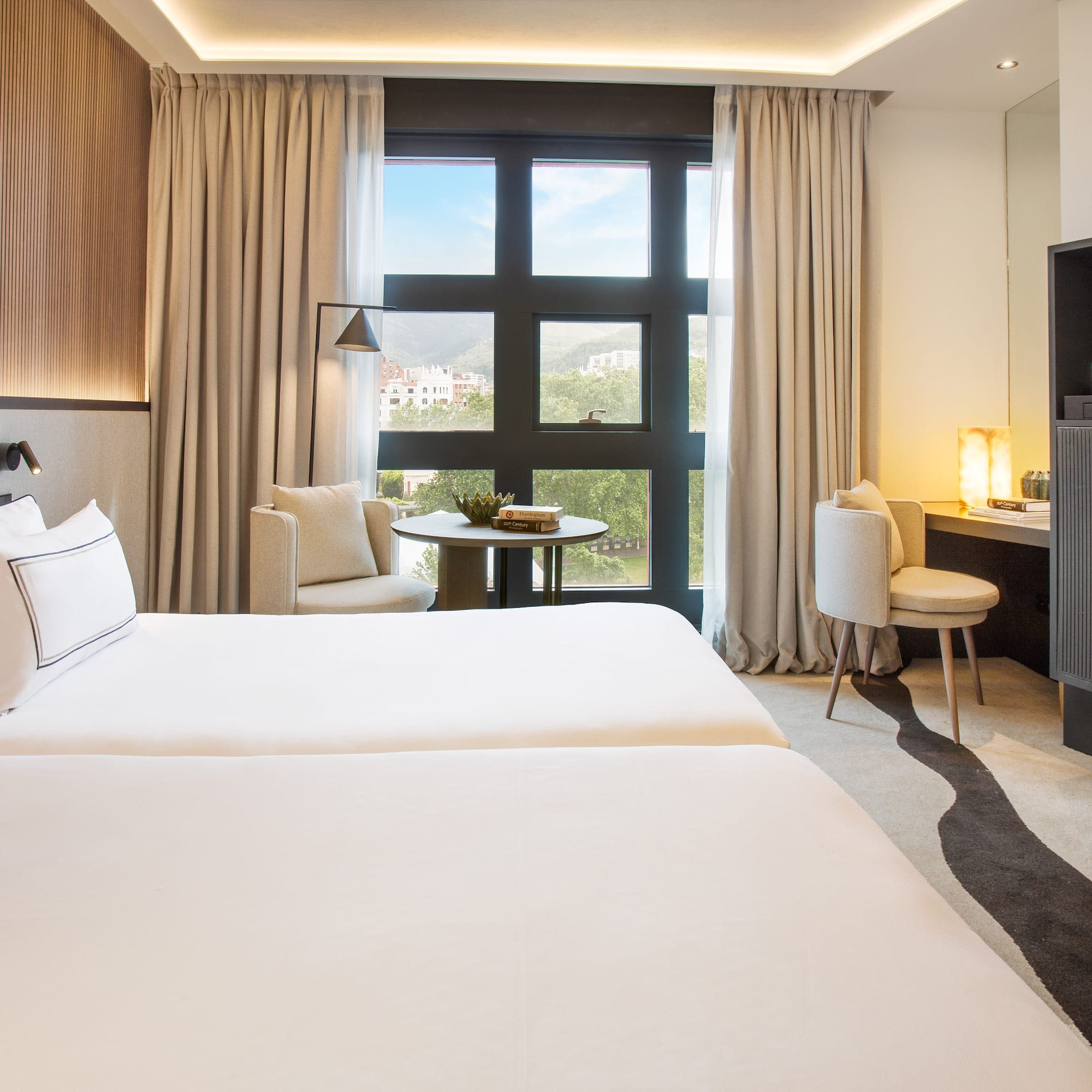 a room with two beds and a fireplace