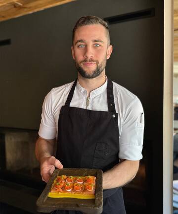 a man holding a tray of food