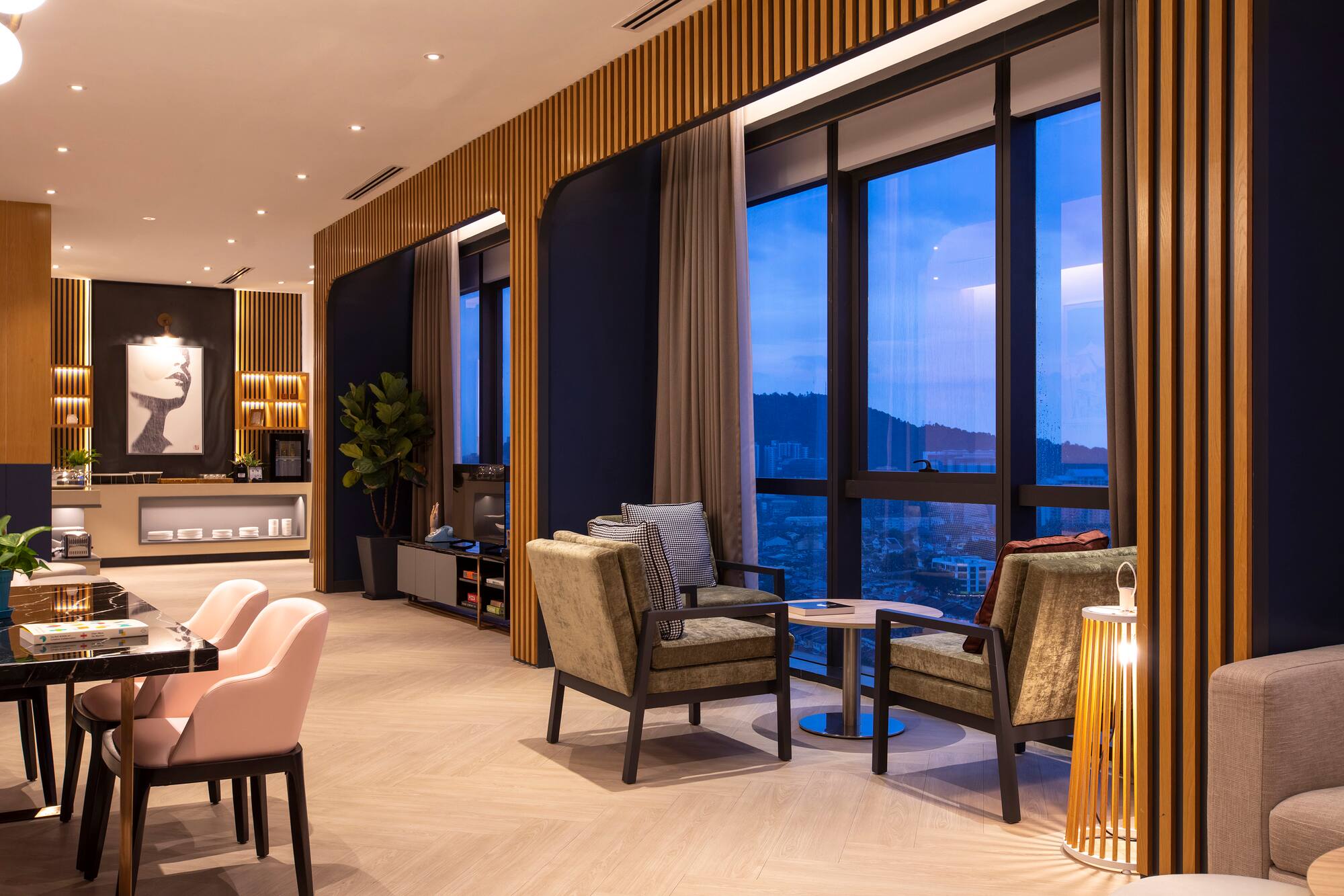 Modern lounge with city view, large windows, wood accents, and stylish furniture.