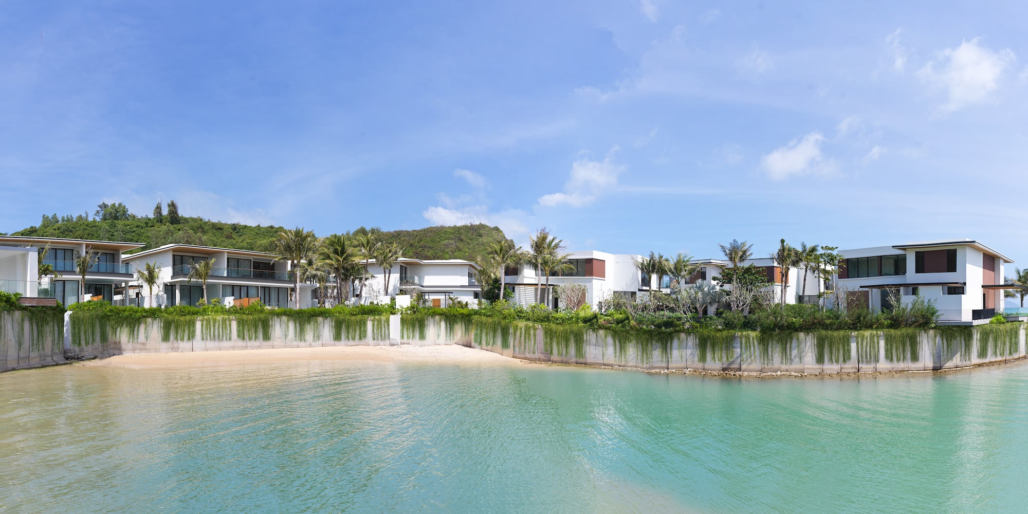 a body of water with houses and trees