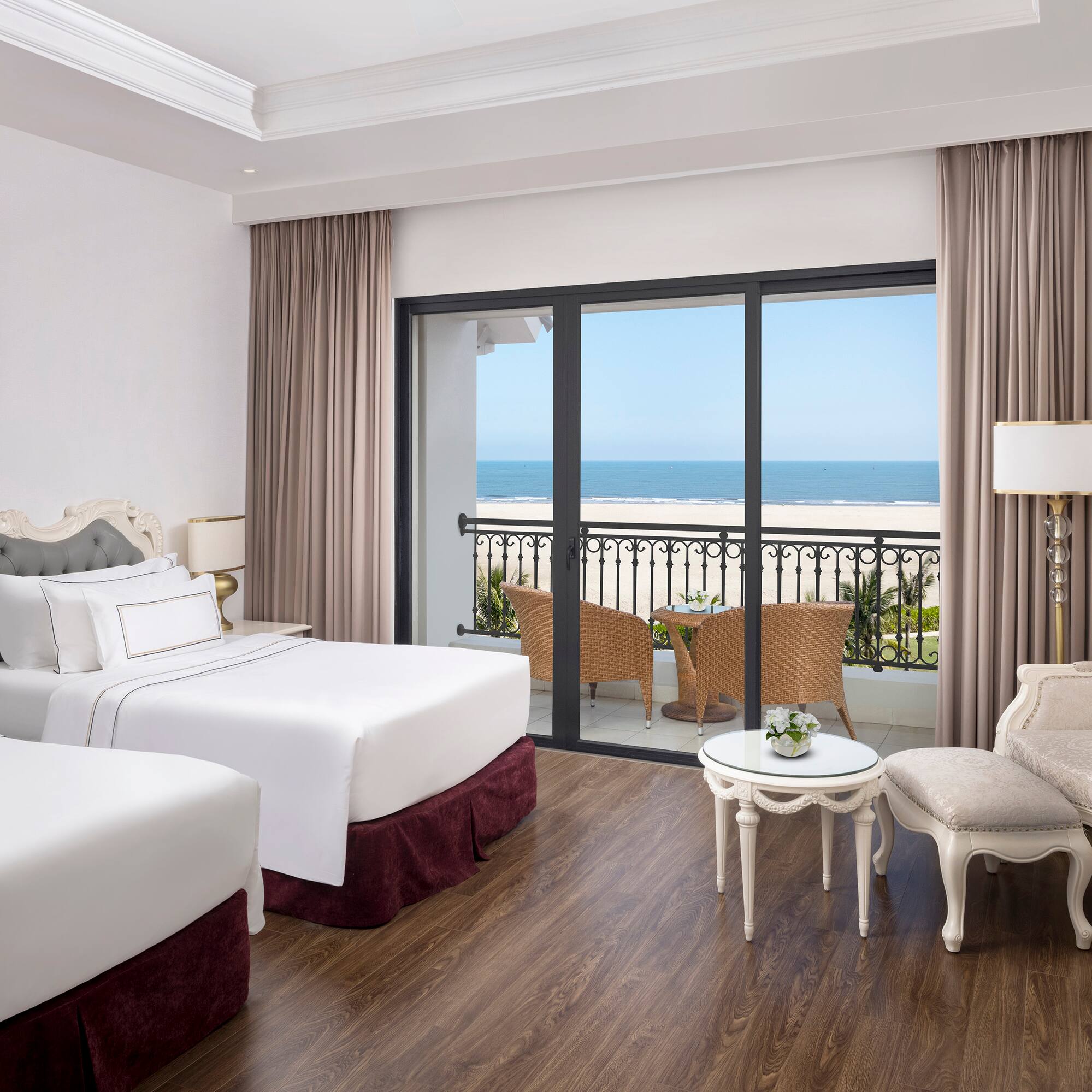 a room with two beds and a table and chairs