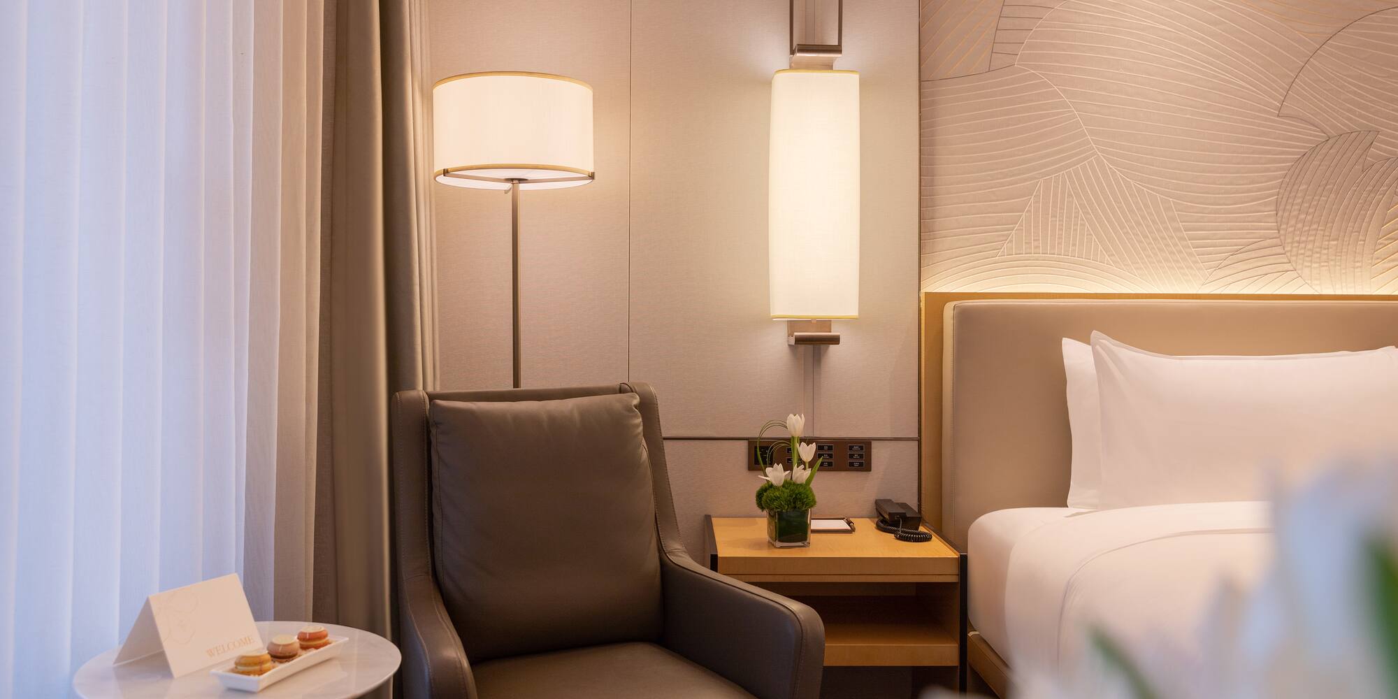 a chair next to a bed